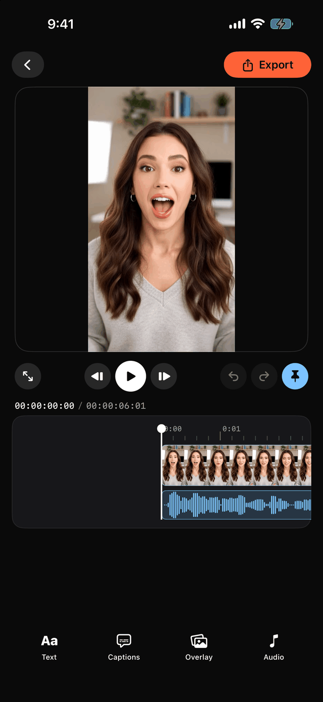 The built-in video editor: a portrait clip in preview, playhead and timecode over a filmstrip timeline, and Text, Captions, Overlay, Audio tools.